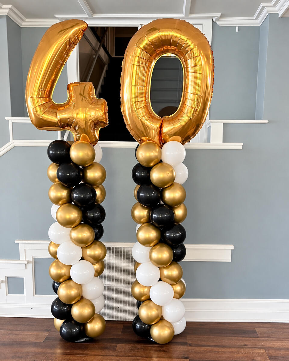 Gold number 40 balloons on black, white and gold balloon columns.